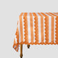 Orange and white striped tablecloth placed on an esthetic table