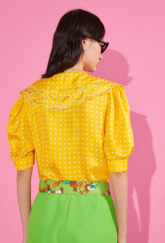 Backside of our yellow shirt with white dots and baby collar 