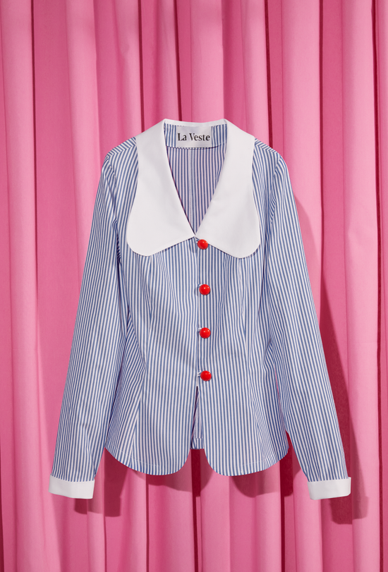 White and blue striped long-sleeved shirt, displayed on a pink background