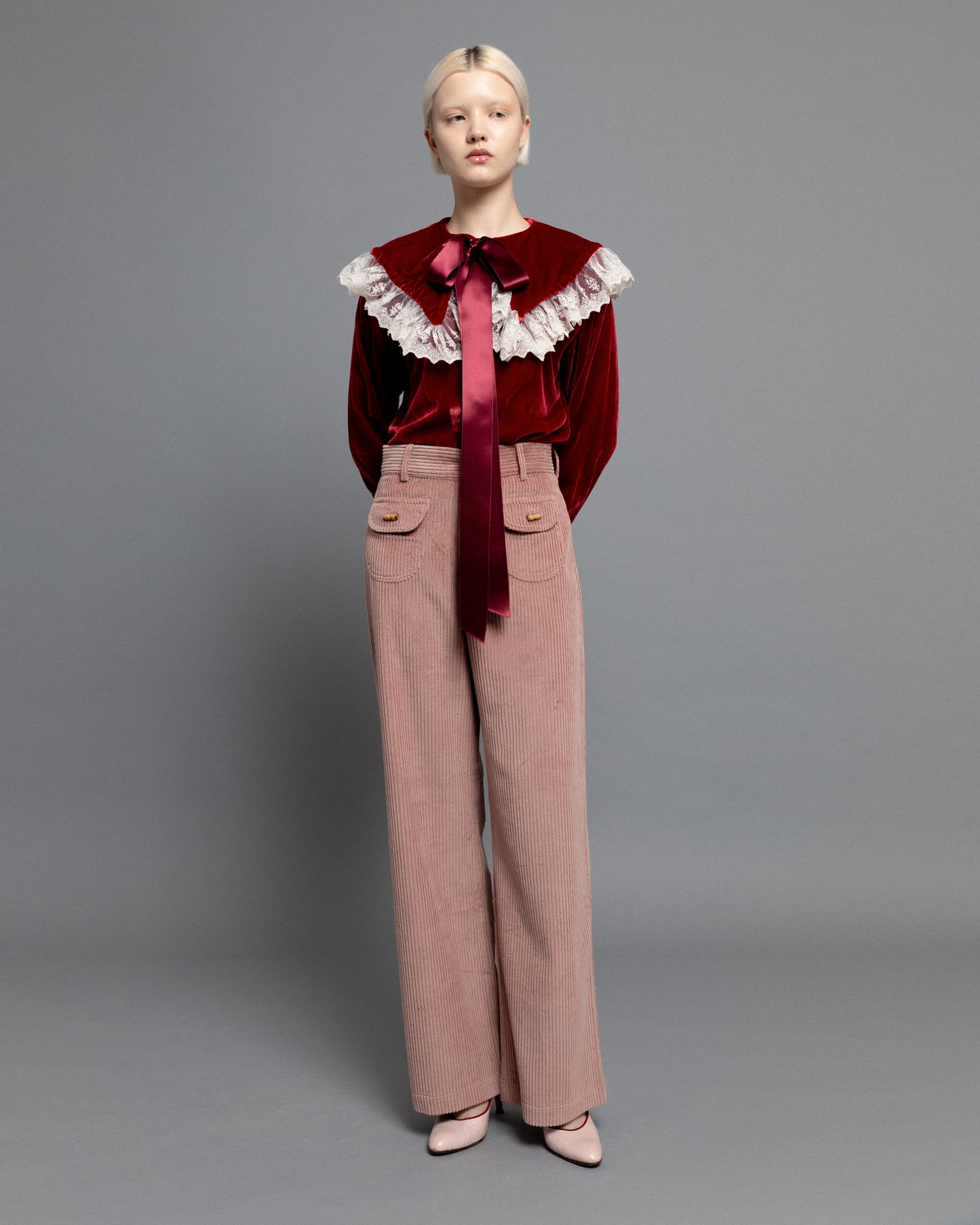 Baby pink high waisted corduroy trousers.