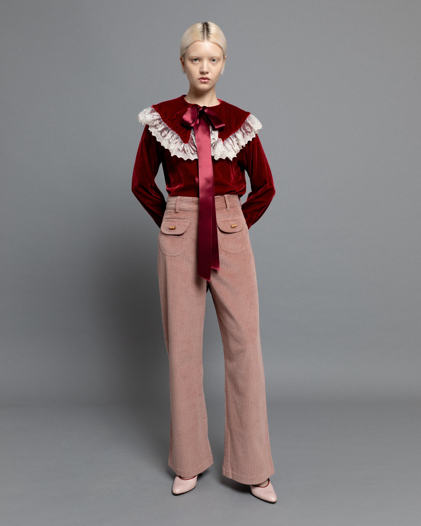 Baby pink high waisted corduroy trousers.