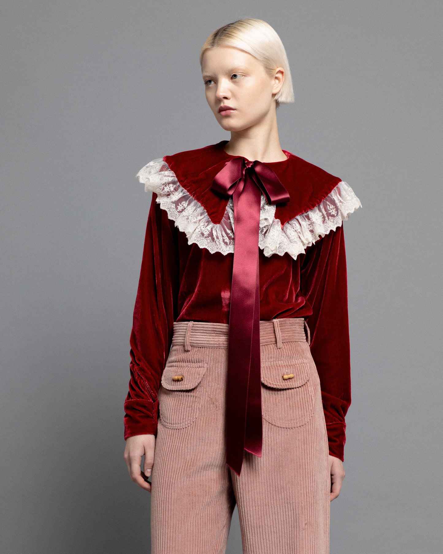 Baby pink high waisted corduroy trousers.