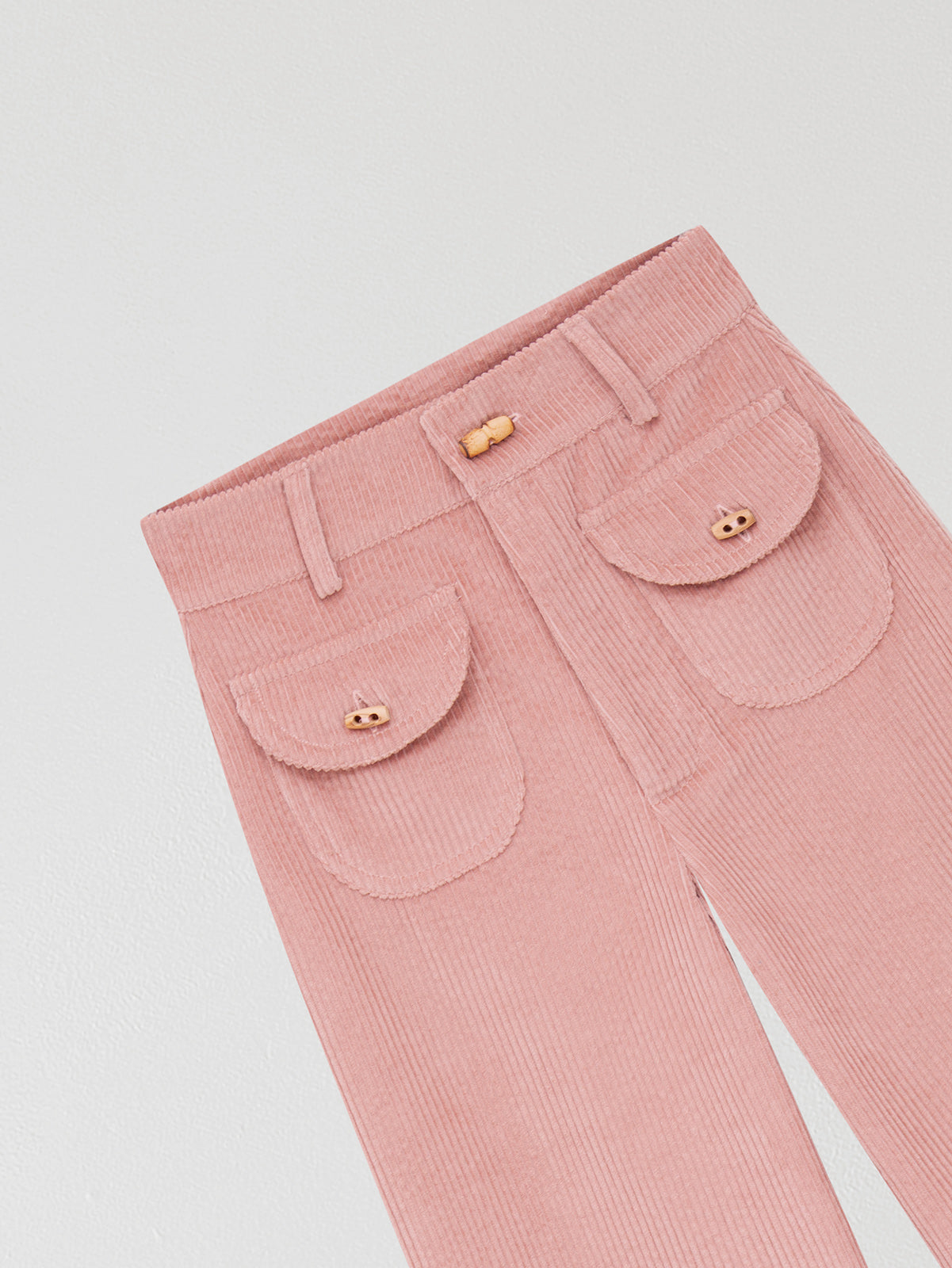 Baby pink high waisted corduroy trousers.