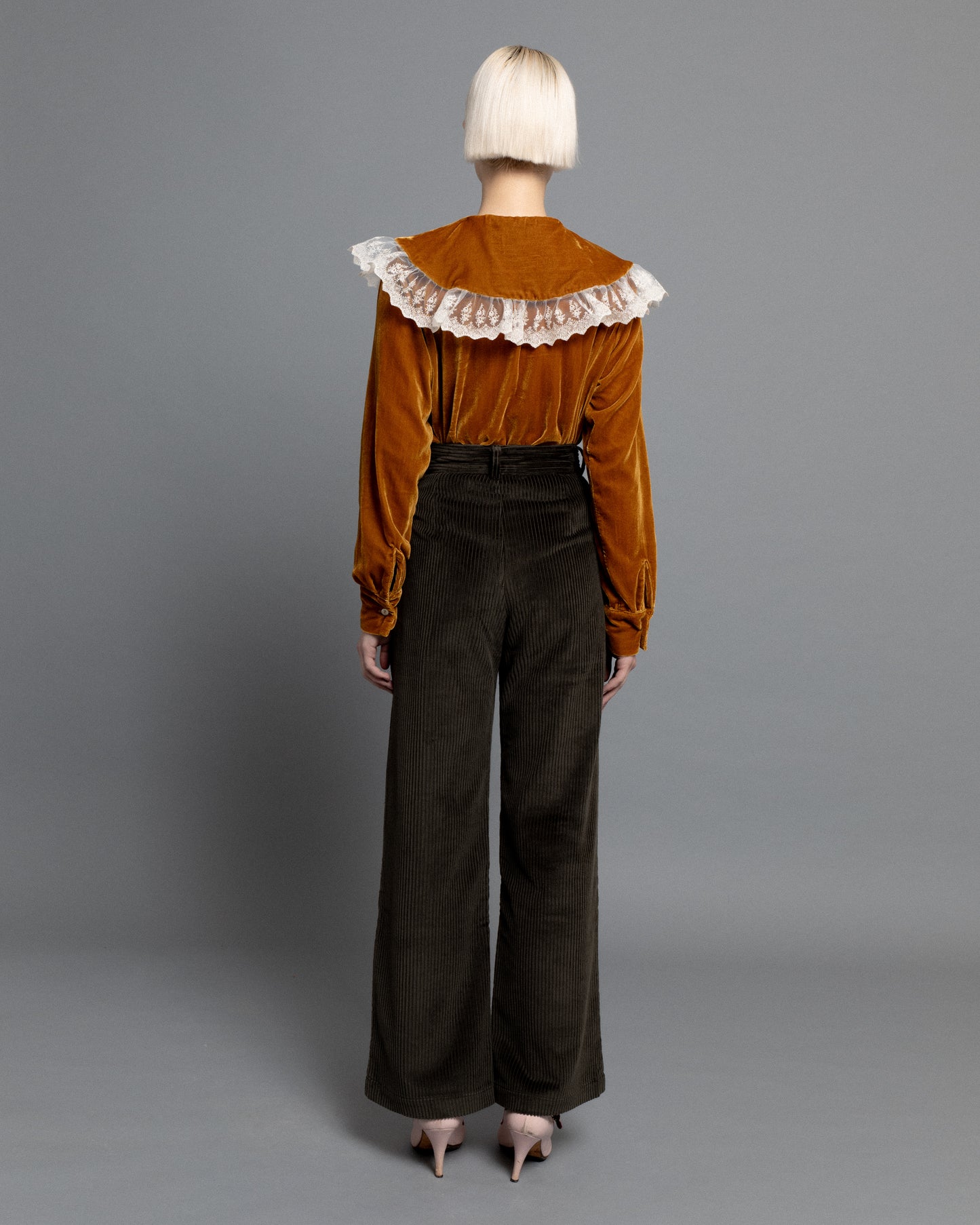 Dark green high waisted corduroy trousers.