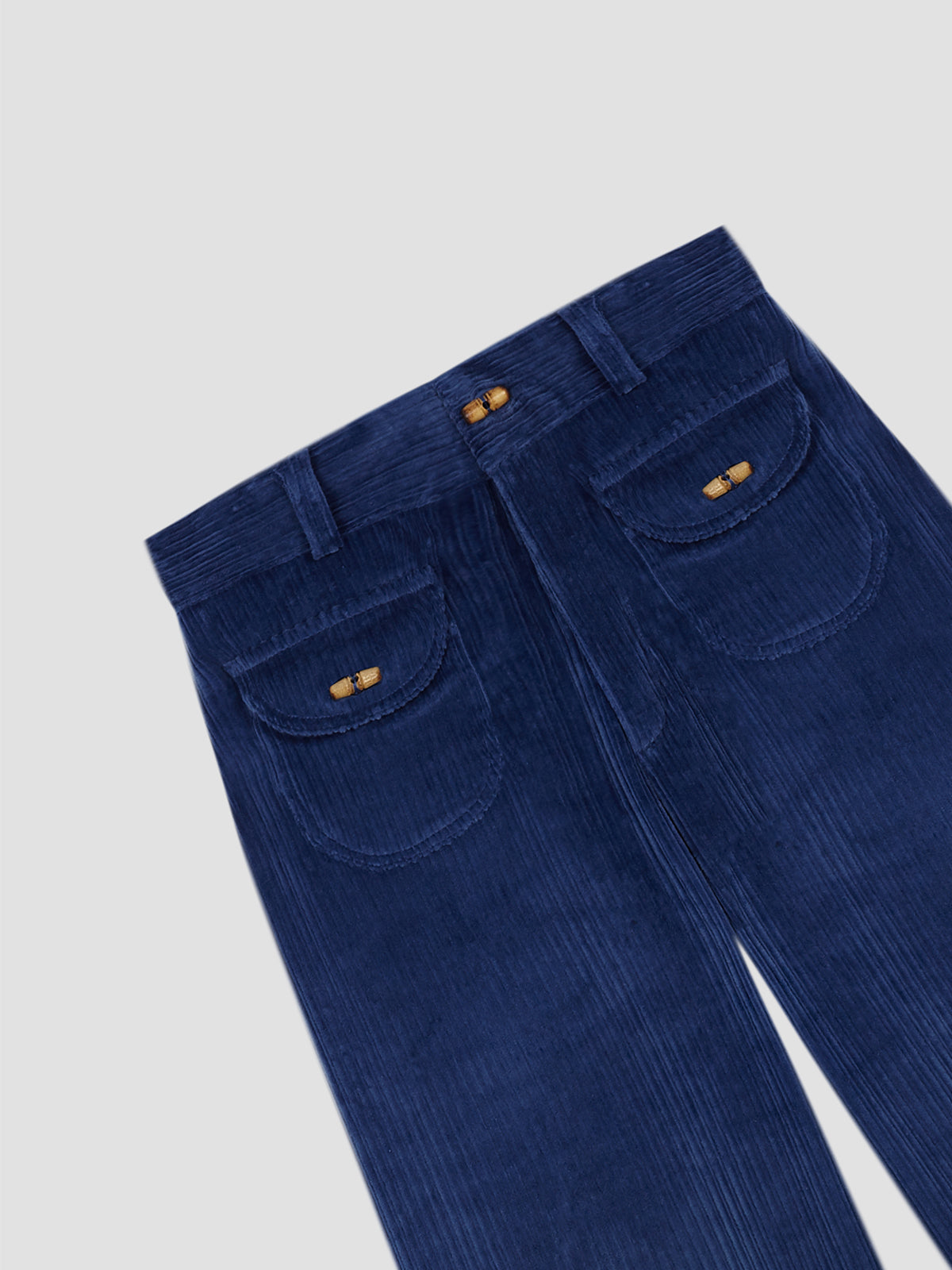 Blue corduroy pants with front pockets, wooden buttons and concealed zipper