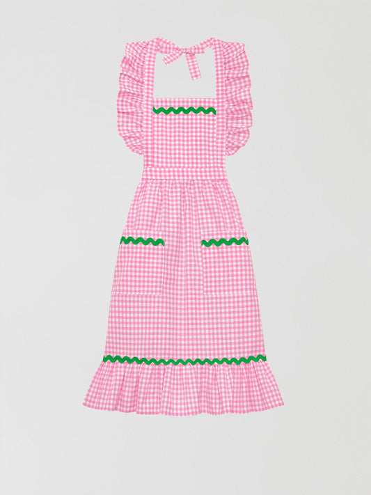 Cocinitas Apron Pink is a pink vichy cotton apron with front pockets and matching green piping details.