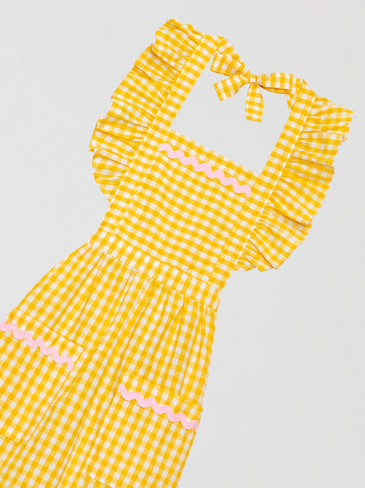 Yellow vichy checkered kitchen apron with ruffles and green details on pockets and skirt