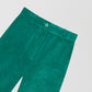 Emerald green velvet trousers.