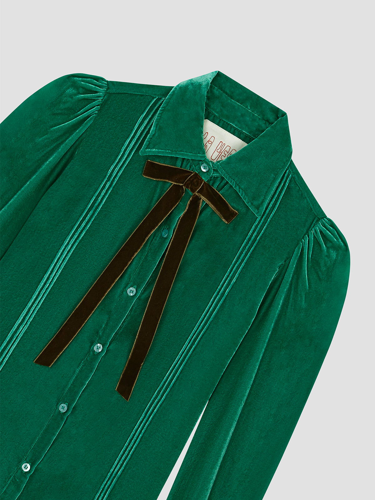 Green velvet shirt with brown bow on the collar