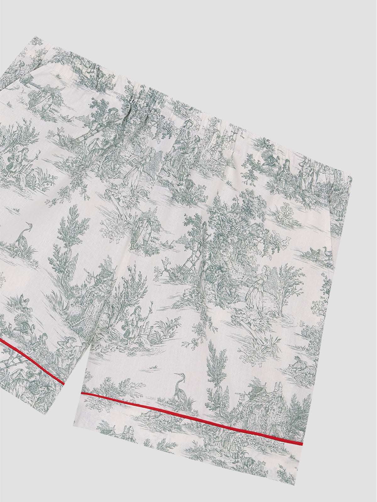 Toile de Jouy print shorts in green with red bias binding details at the bottom