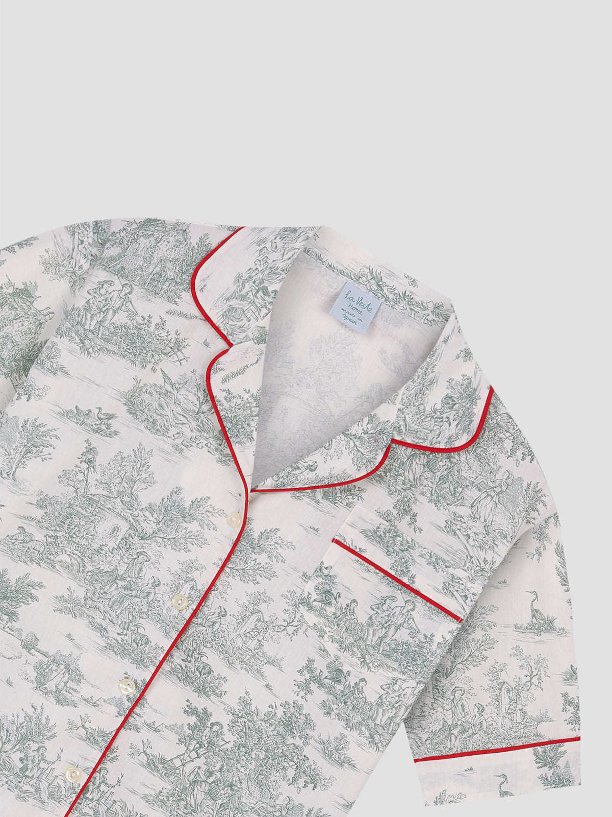 Pajama shirt with green Toile de Jouy print, button closure and red bias detail on edges and pockets.