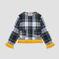 Checked jacket in shades of navy, green and yellow with yellow fringe detail at the bottom