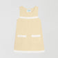 Fringes Mini Towel Vanilla is a vanilla-colored dress with two front pockets and white bangs on the chest and bottom.