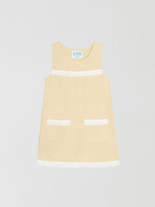 Fringes Mini Towel Vanilla is a vanilla-colored dress with two front pockets and white bangs on the chest and bottom.