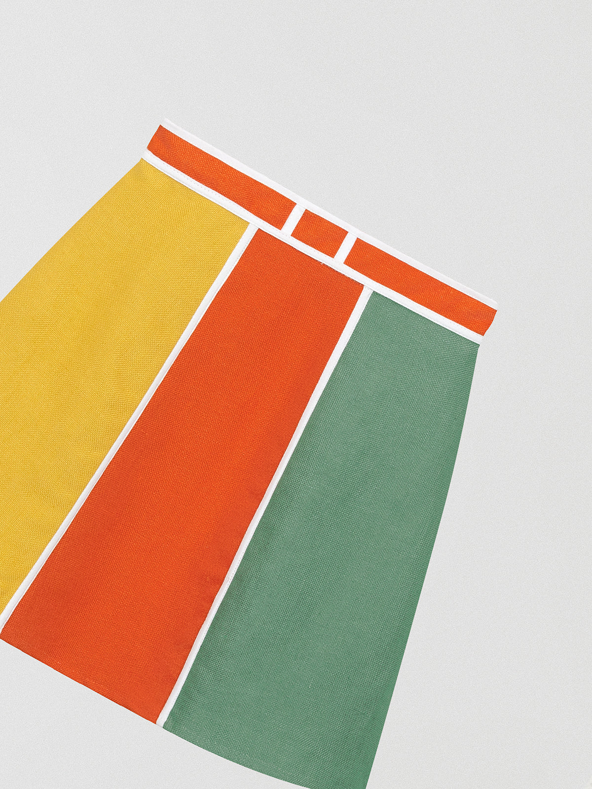 Flared linen mini skirt with asymmetric print in orange, yellow and green.
