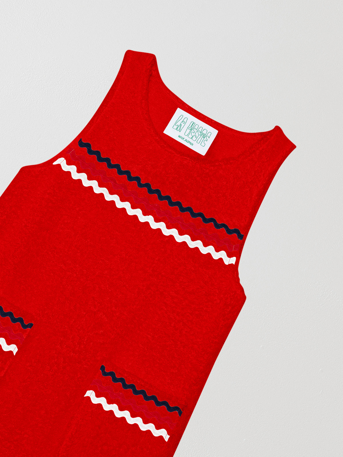 Short red dress with navy blue, pink and white piping details on front pockets and front pockets