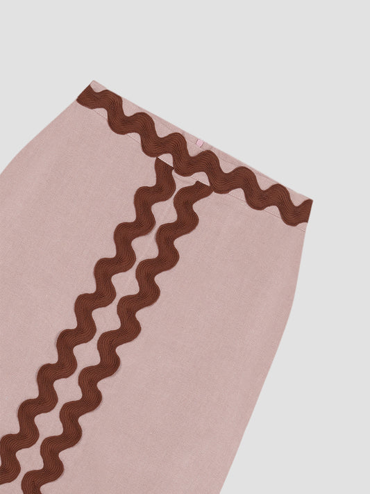 Midi skirt made in pink linen with brown trim detail