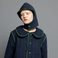 Close-up view of our navy quilted hood with green piping details