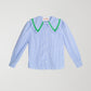 Blue and white vichy check shirt made of cotton with green trim detail on the collar