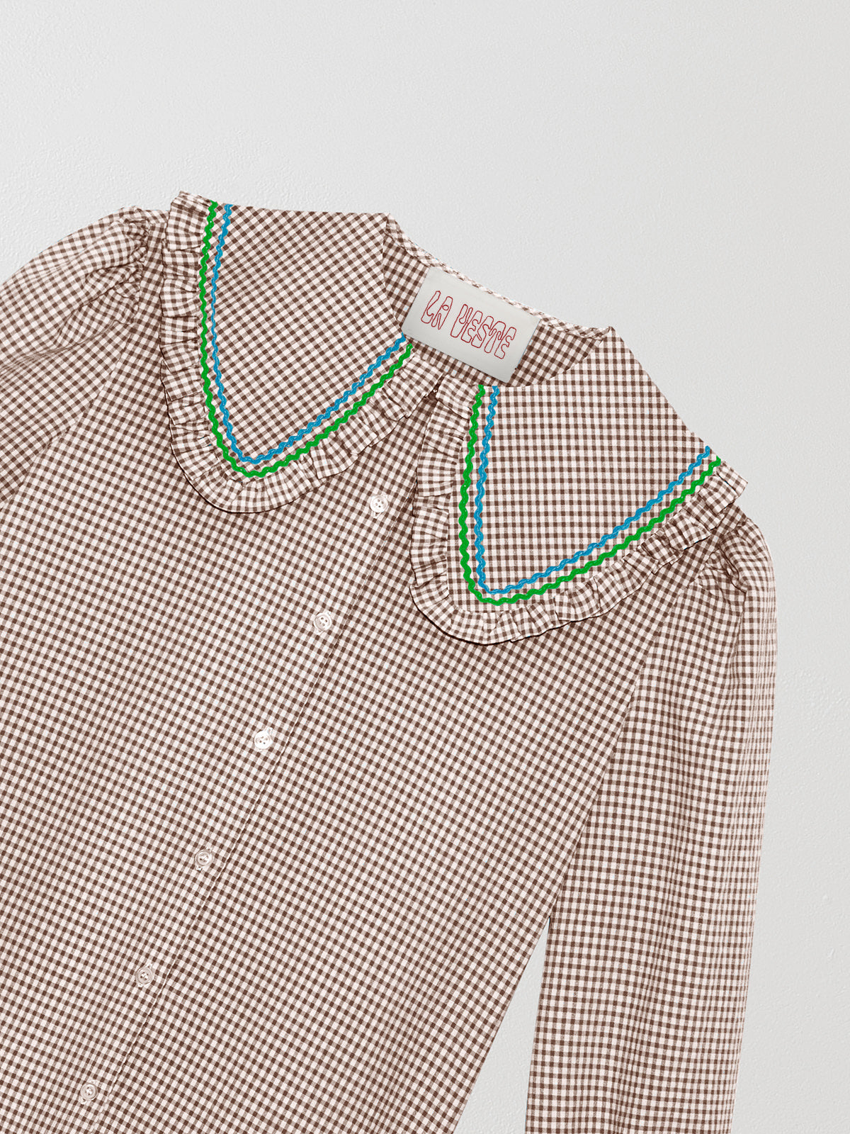 Brown and white vichy check shirt made of cotton with blue and green yarn detail on the collar