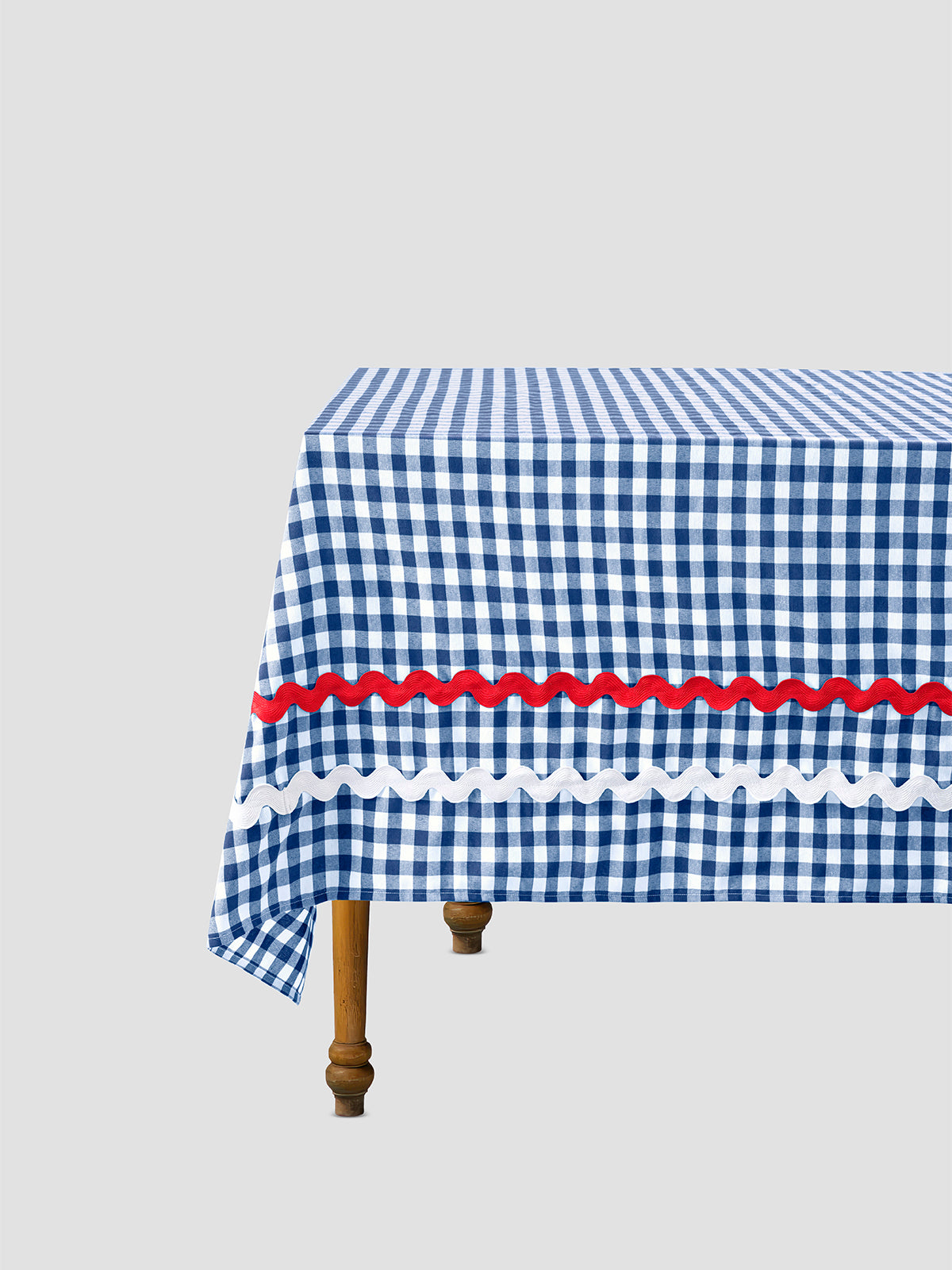 Rectangular tablecloth made of blue and white vichy check cotton with red and white trim