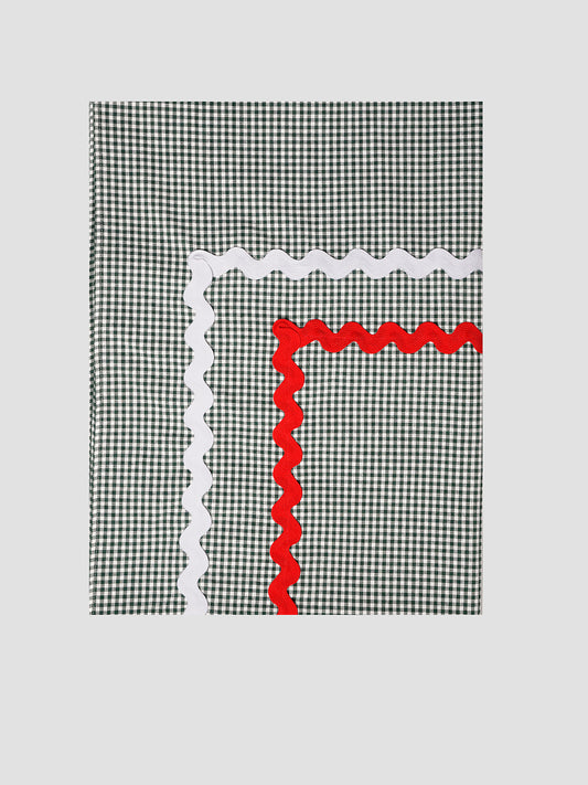 Tablecloth Mini Check Green is a rectangular green check tablecloth with red and white piping detail.