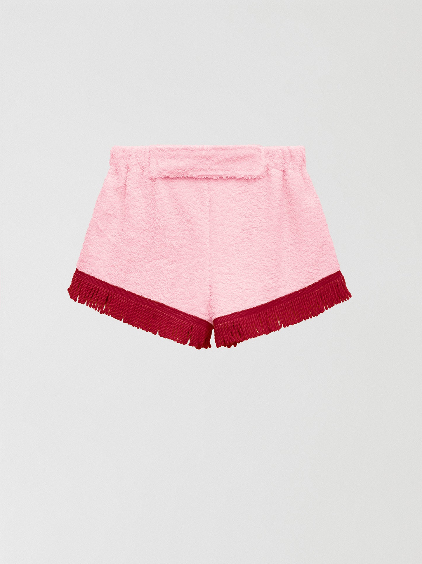 Towel shorts made in pink cotton with red fringes. 