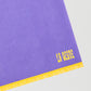 Towel made in purple cotton with yellow fringes detail. 