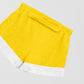 Towel shorts made in yellow cotton with white fringes. 
