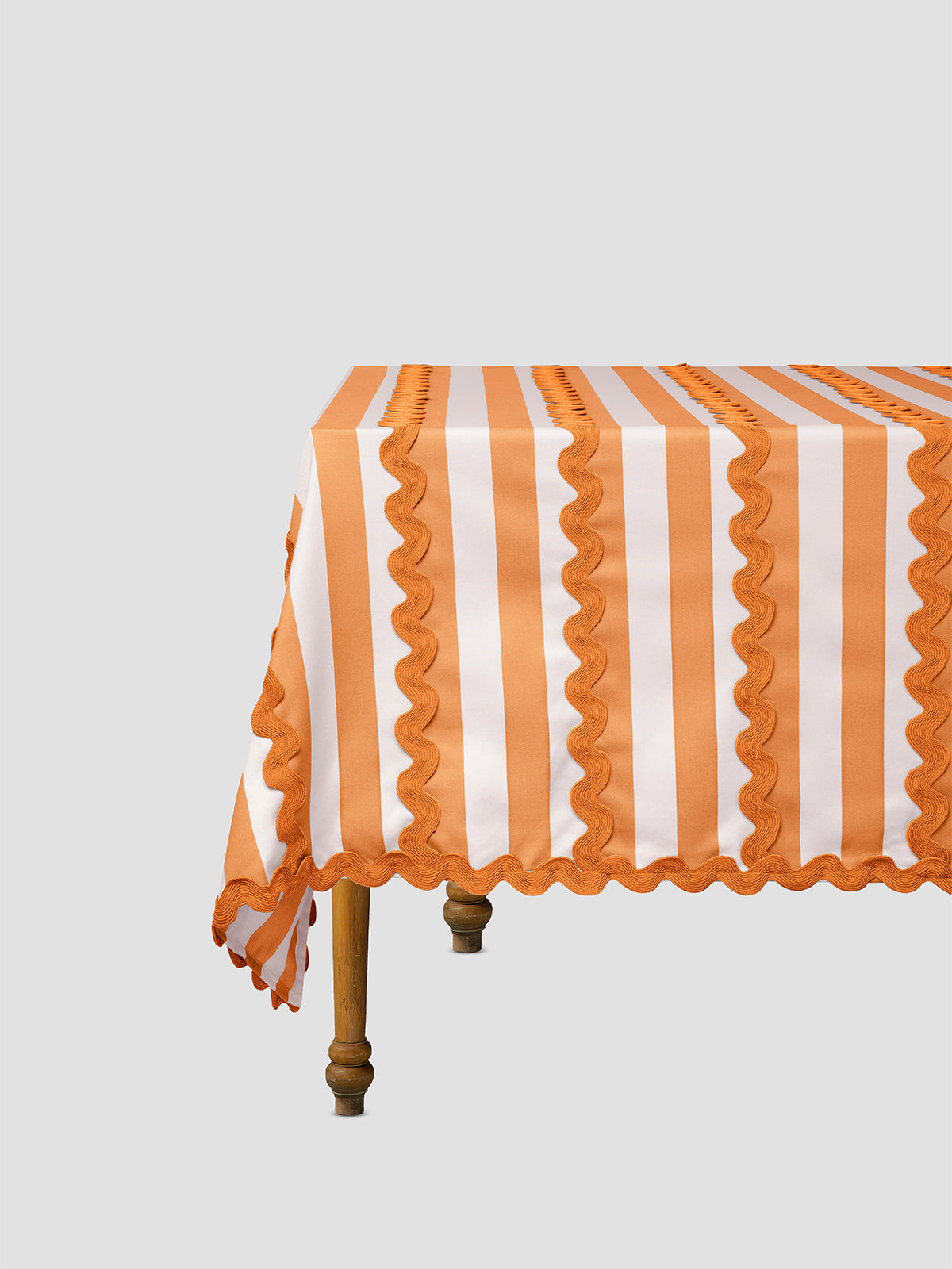 Orange and white striped tablecloth placed on an esthetic table