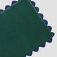 Green velvet tablecloth with blue piped borders 