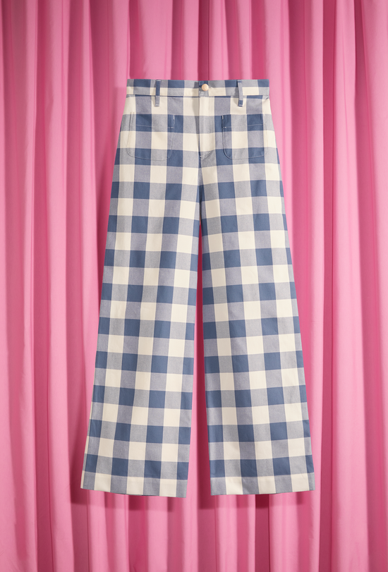 High-waisted pants with exposed white and blue checks on a pink background