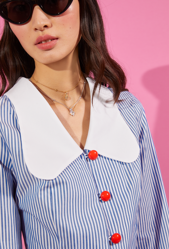 Close-up view of our striped shirt with red buttons