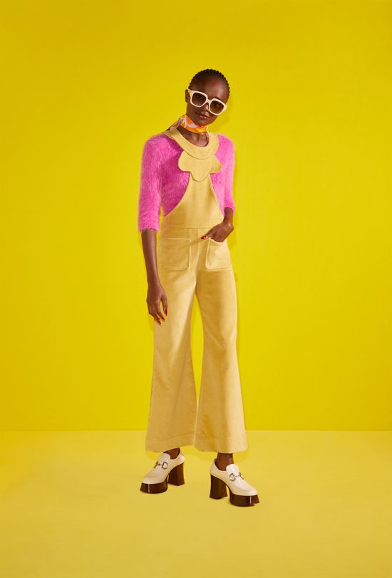 Model wearing a yellow jumper with a pink towel fabric shirt.