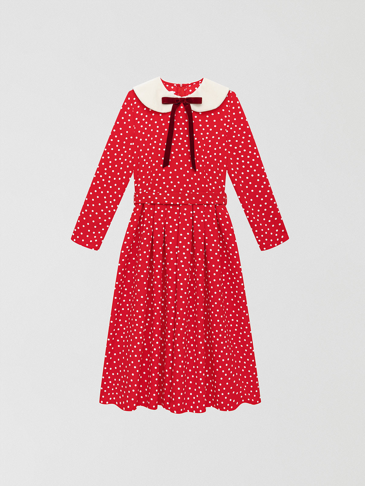 Color: Red/White.  Red blue and white polka dots dress made of cotton with velvet baby collar in ecru.   Regular fit. Midi length. Waistband with sash lined in the same fabric.  Flared skirt. Round neck made in ecru velvet with burgundy velvet bow closure in the center.  Long sleeves. Zipper closure at the back.