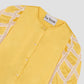 Shirt made of mustard colored silk and rounded collar. It has sleeves above the elbow with raw lace detail. Button closure.