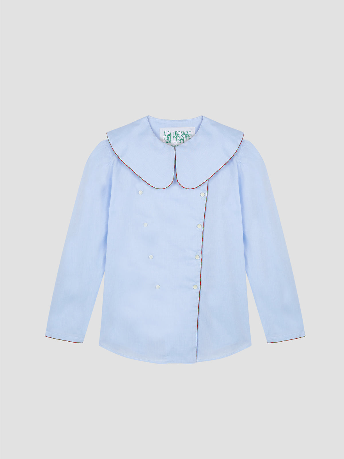 Augusta Shirt Celeste is a blue long sleeve shirt with brown piping details and white button closure.