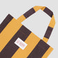 Mustard and chocolate striped tote bag with matching La Veste logo in the middle