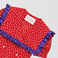 Red shirt with polka dots and square ruffle on the collar