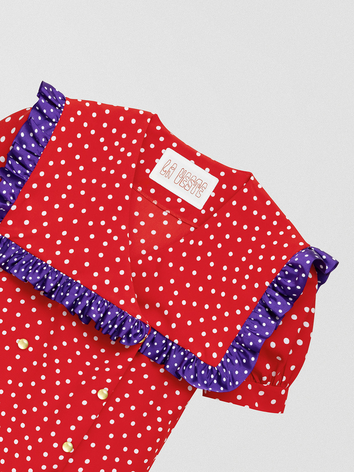 Red shirt with polka dots and square ruffle on the collar