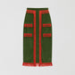 Green velvet pencil skirt with orange fringed design on the front, bottom and top. 