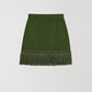 Mini skirt made in green velvet with light green fringes at the bottom.