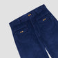 Blue corduroy pants with front pockets, wooden buttons and concealed zipper