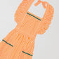 Orange and white long apron with matching green onduline details