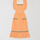 Cocinitas Apron Orange is an orange apron with ruffled straps and matching green onduline.