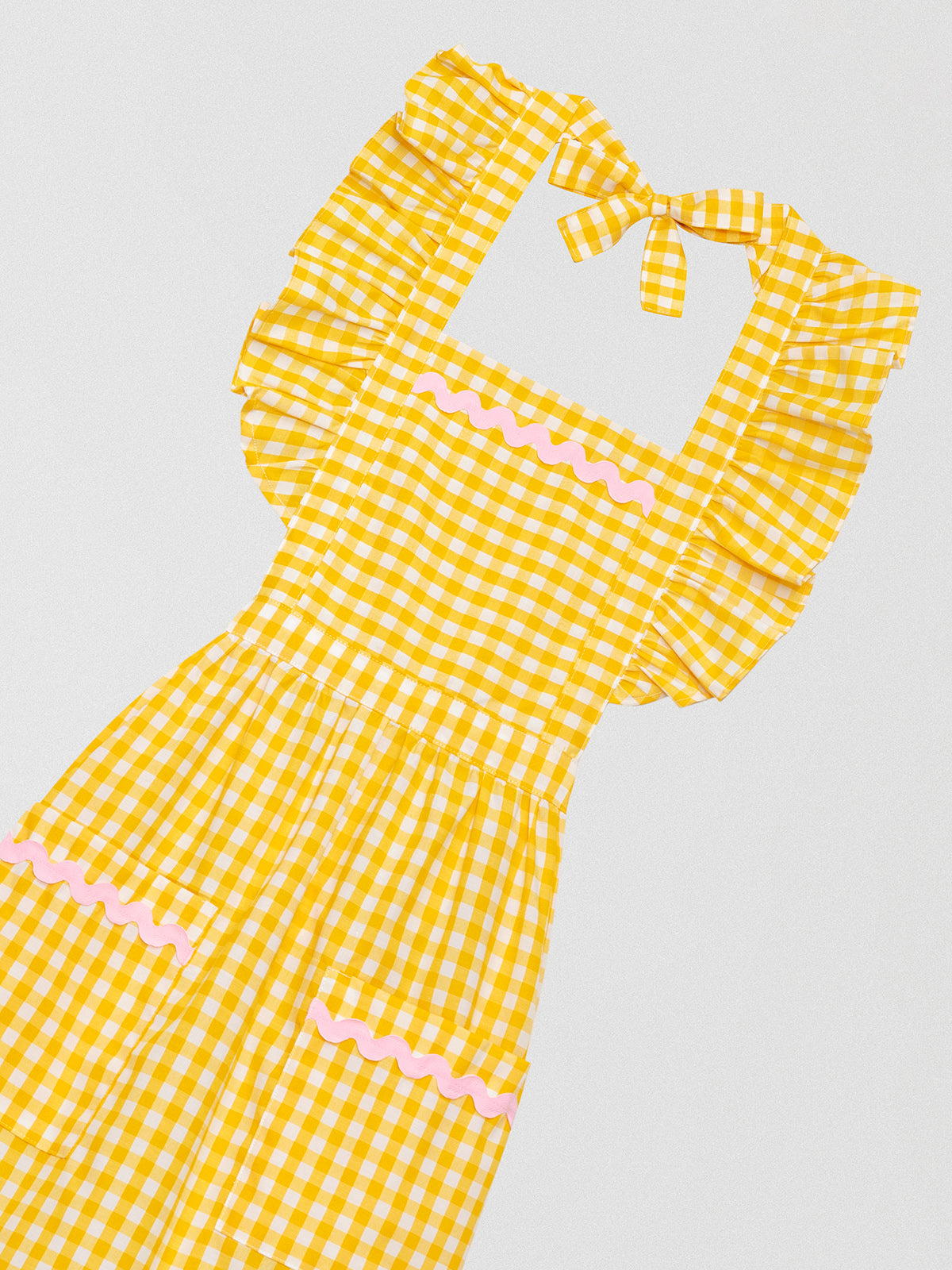 Yellow vichy checkered kitchen apron with ruffles and green details on pockets and skirt 