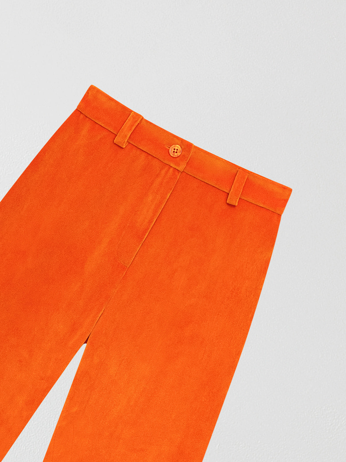 Orange velvet trousers.