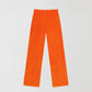 Orange velvet trousers.
