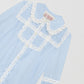 Light blue shirt with geometric lace pattern and pleated details