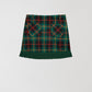 Plaid mini skirt in green, red and yellow with fringed detail at the bottom. 